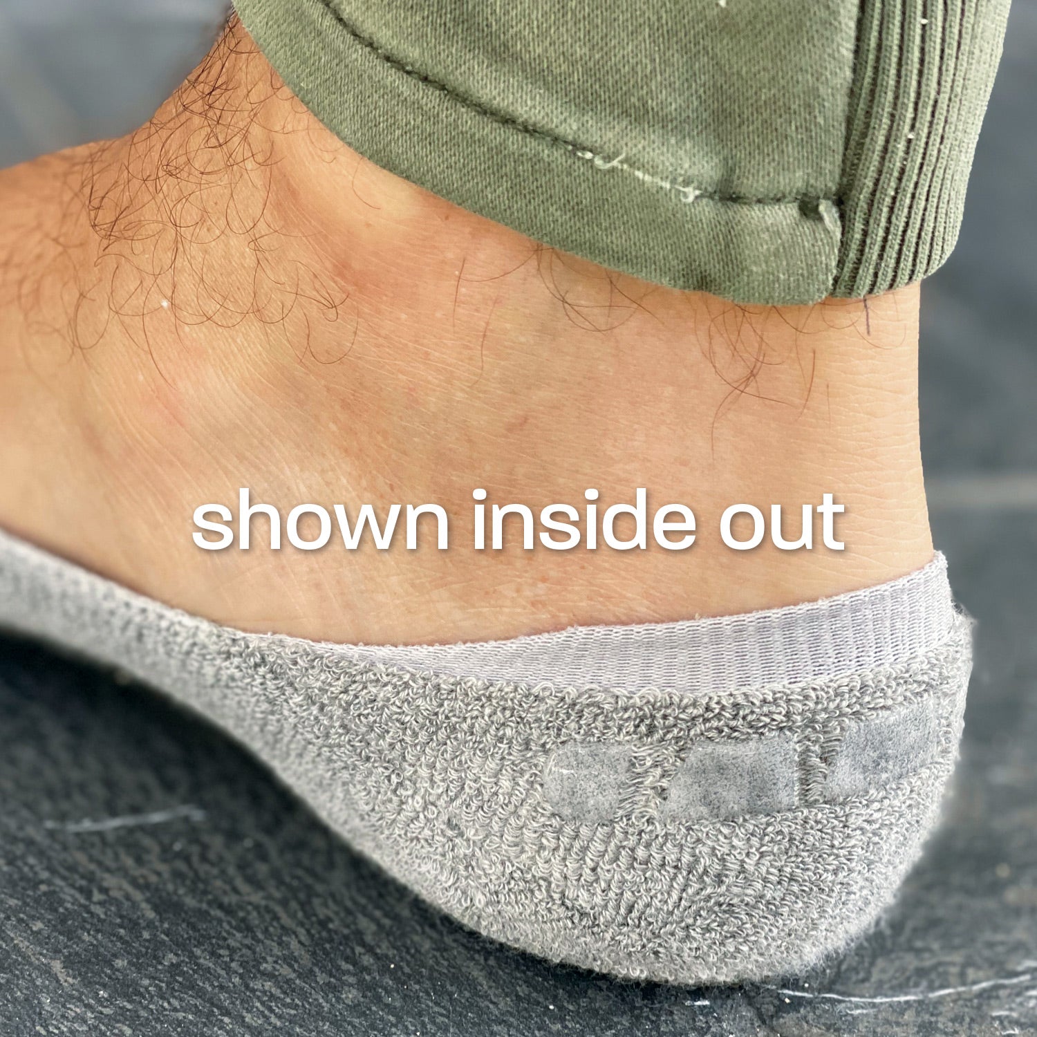 Photo showing close-up of Skinnys Invisibles sock heel-cup inside out on a man's foot, revealing padding and wrap-around gel grip