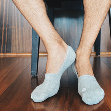 Load image into Gallery viewer, Photo of man&#39;s legs and feet wearing Skinnys Invisibles padded-heel socks
