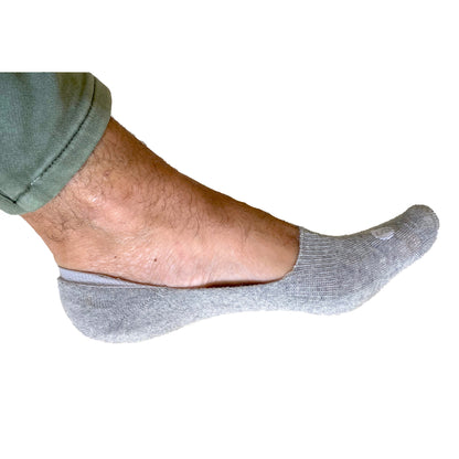 Photograph of a Skinnys Invisibles padded-heel sock on a man's foot from the side, on a white studio background, revealing low-cut nature of sock