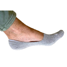 Load image into Gallery viewer, Photograph of a Skinnys Invisibles padded-heel sock on a man&#39;s foot from the side, on a white studio background, revealing low-cut nature of sock
