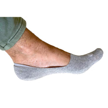 Load image into Gallery viewer, Photograph of a Skinnys Invisibles padded-heel sock on a man&#39;s foot from the side, on a white studio background, revealing low-cut nature of sock
