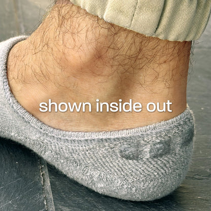 Photo showing close-up of Skinnys Performance sock heel-cup inside out on a man's foot, revealing padding and wrap-around gel grip
