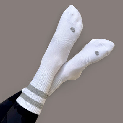 Photo of a woman's legs crossed in the air wearing Skinnys Tubes crew socks