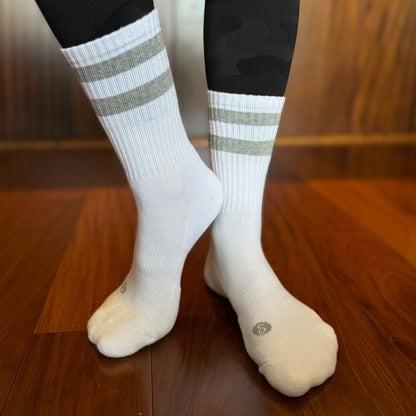 Photo of a woman's legs and feet wearing Skinnys Tubes padded-heel crew socks